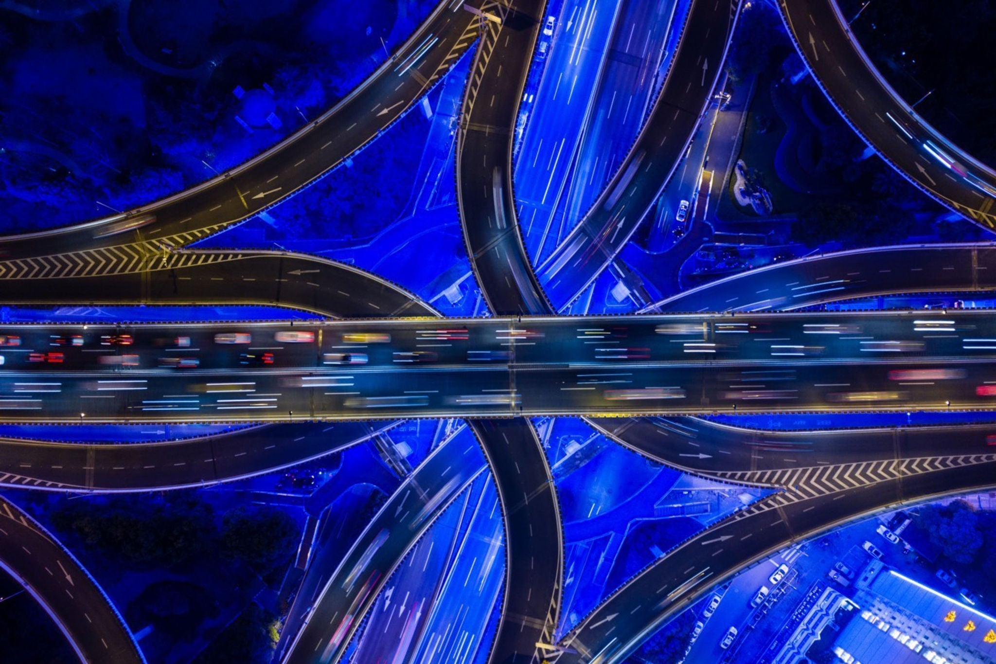 EY aerial view of flyover roads illuminated in blue light